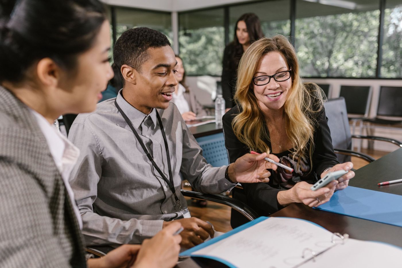 Consultant reviewing plans with business owners at a meeting table