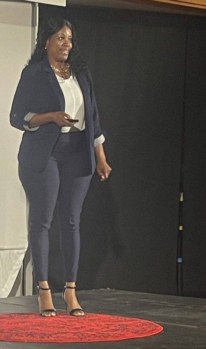 Fatima Blair speaking on stage at TEDxHighPoint